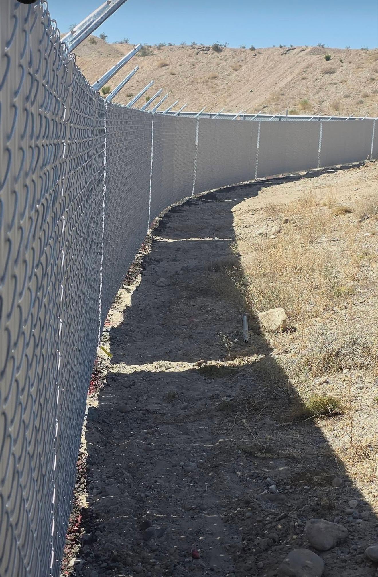 Long chain-link fence with privacy screening